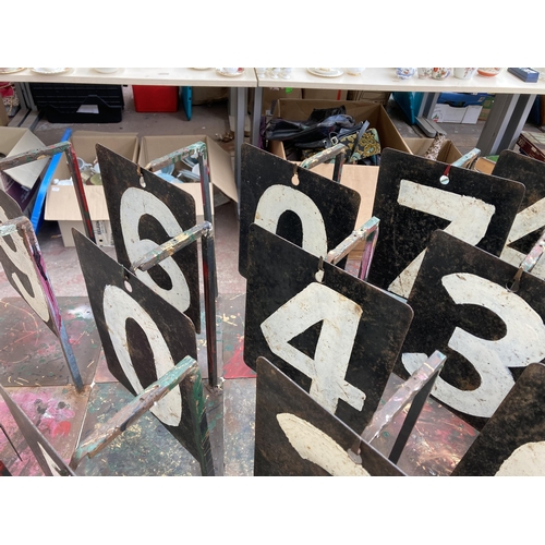 551 - Twenty three vintage hand-painted on steel cricket numbers on bespoke wrought iron stands - approx. ... 