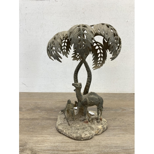 552 - An early 20th century middle eastern cast brass camel and owner under palm tree sculpture - approx. ... 