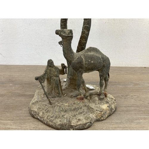 552 - An early 20th century middle eastern cast brass camel and owner under palm tree sculpture - approx. ... 