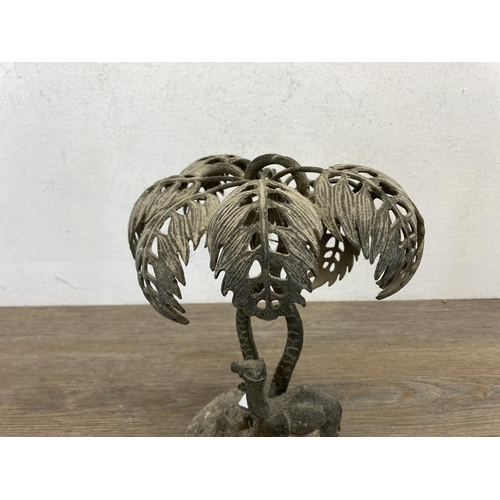 552 - An early 20th century middle eastern cast brass camel and owner under palm tree sculpture - approx. ... 