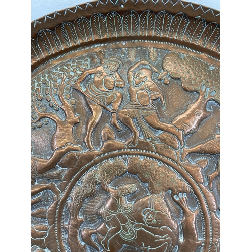 553 - An early 20th century Indian embossed copper wall charger approx. 47cm diameter