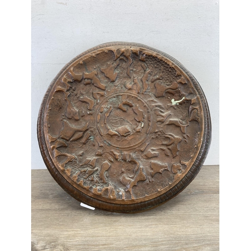 553 - An early 20th century Indian embossed copper wall charger approx. 47cm diameter