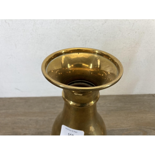 558 - A pair of 19th century brass John Smyth & Sons (Dublin) Ltd. ecclesiastical engraved vases - approx.... 