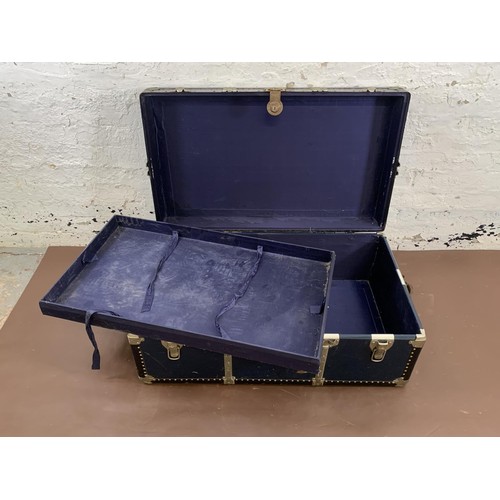 198 - A mid 20th century blue painted and metal banded travel trunk - approx. 36cm high x 92cm wide x 54cm... 