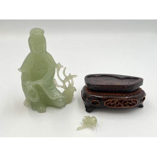 2062 - A hand carved jade Buddha figurine on hardwood stand - approx. 11cm high