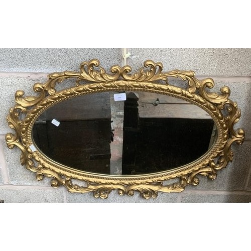 303 - A modern Rococo style oval gilt framed wall mirror - approx. 81cm high x 53cm wide