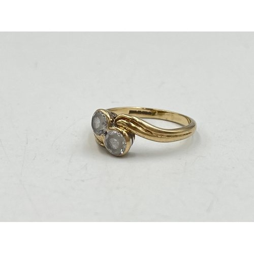 2016 - A hallmarked Birmingham 9ct gold CZ two stone twist setting ring, size M - approx. gross weight 2.4g