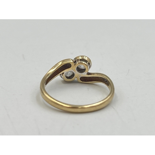 2016 - A hallmarked Birmingham 9ct gold CZ two stone twist setting ring, size M - approx. gross weight 2.4g