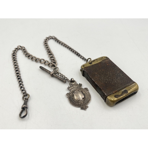 2040 - An early 20th century brass vesta case with fitted hallmarked sterling silver Albert chain, T-bar an... 