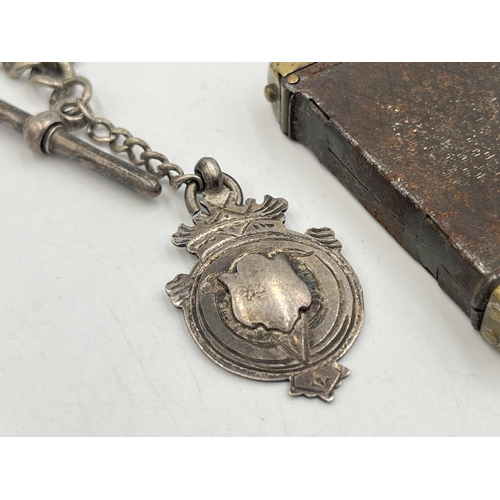 2040 - An early 20th century brass vesta case with fitted hallmarked sterling silver Albert chain, T-bar an... 