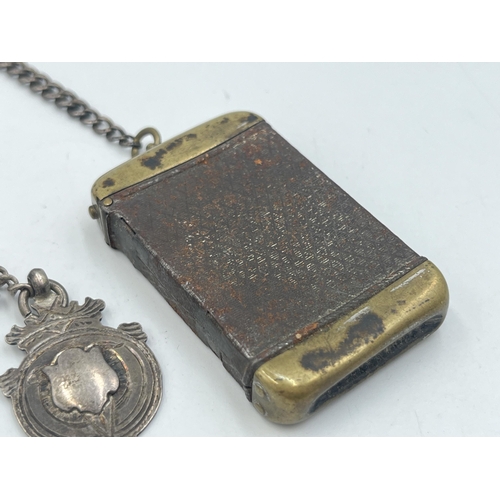 2040 - An early 20th century brass vesta case with fitted hallmarked sterling silver Albert chain, T-bar an... 