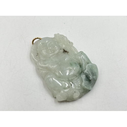 2050A - A carved jadeite buddha pendant - approx. 5cm high x 3.5cm wide