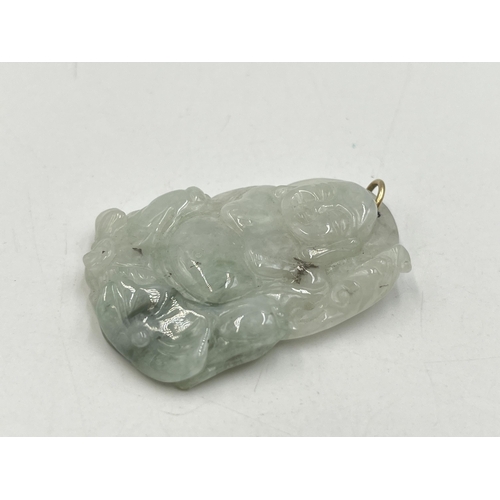 2050A - A carved jadeite buddha pendant - approx. 5cm high x 3.5cm wide