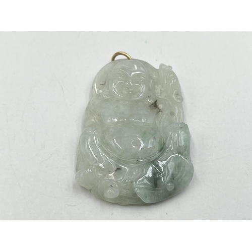 2050A - A carved jadeite buddha pendant - approx. 5cm high x 3.5cm wide