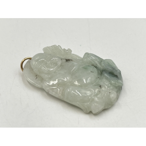 2050A - A carved jadeite buddha pendant - approx. 5cm high x 3.5cm wide