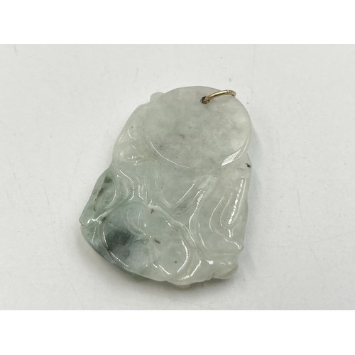 2050A - A carved jadeite buddha pendant - approx. 5cm high x 3.5cm wide