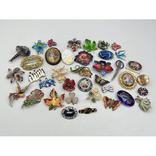 2057 - A collection of brooches to include Catherine Popesco France, sterling silver and enamel etc.