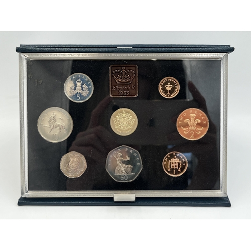 2080 - Three cased Royal Mint United Kingdom coin sets, one 1983 proof seven coin, one 1991 proof eight coi... 