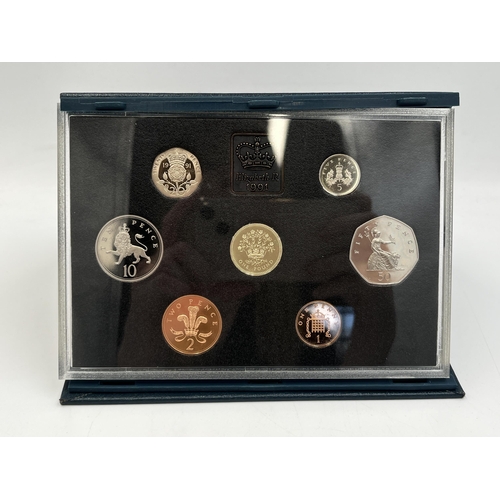 2080 - Three cased Royal Mint United Kingdom coin sets, one 1983 proof seven coin, one 1991 proof eight coi... 