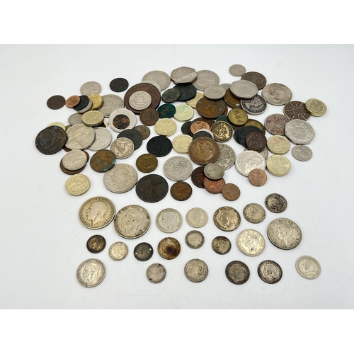 2082 - A collection of world coins to include approx. 92g of 50% silver British examples