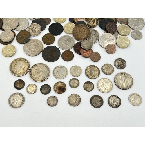 2082 - A collection of world coins to include approx. 92g of 50% silver British examples