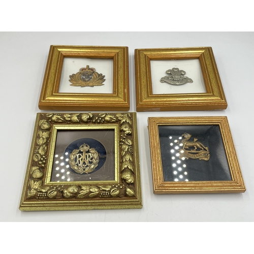 2093 - Four framed military cap badges