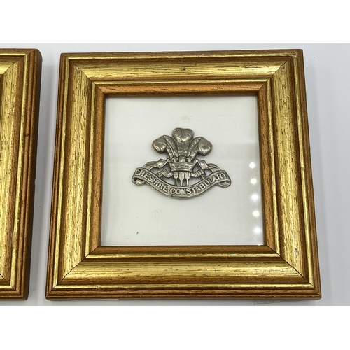 2093 - Four framed military cap badges