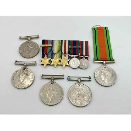 2099 - Six items, one WWII The Defence medal, three WWII War medals, one Africa Service medal and one minia... 