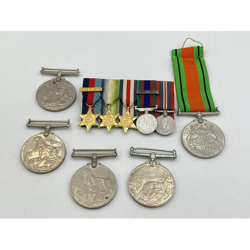 2099 - Six items, one WWII The Defence medal, three WWII War medals, one Africa Service medal and one minia... 