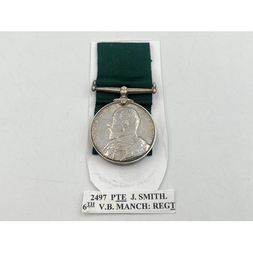 2103 - A Long Service Volunteer Force medal presented to 2497 Pte. J. Smith. 6th V.B. Manch. Regt.