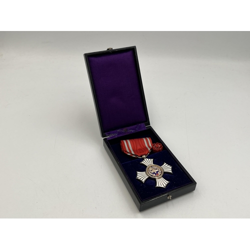 2125 - A cased Japanese Red Cross Society Golden Order of Merit medal