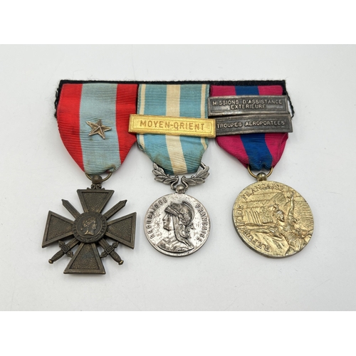 2143 - A WWII French medal trio, one Croix de Guerre, one Colonial 2nd type and one National Defence