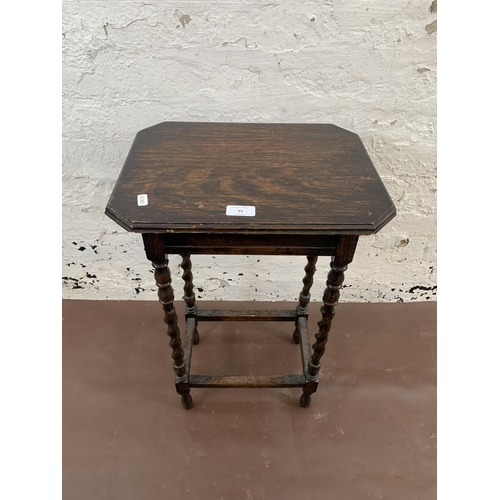 93 - An early 20th century oak barley twist side table - approx. 62cm high x 40cm wide x 30cm deep