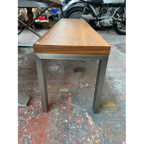105 - A Dwell walnut effect and brushed steel crossed leg extendable dining table with bench - approx. 75c... 