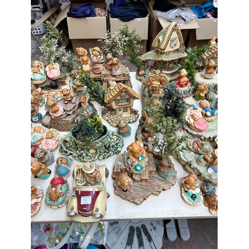 518 - An extensive collection of Pendelfin rabbit figurines and display stands to include Daisy Duck, Coll... 