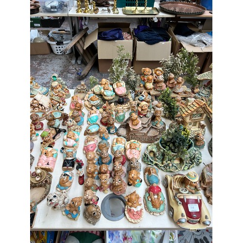 518 - An extensive collection of Pendelfin rabbit figurines and display stands to include Daisy Duck, Coll... 