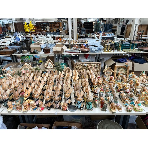 518 - An extensive collection of Pendelfin rabbit figurines and display stands to include Daisy Duck, Coll... 