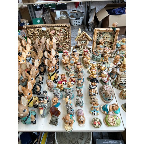 518 - An extensive collection of Pendelfin rabbit figurines and display stands to include Daisy Duck, Coll... 