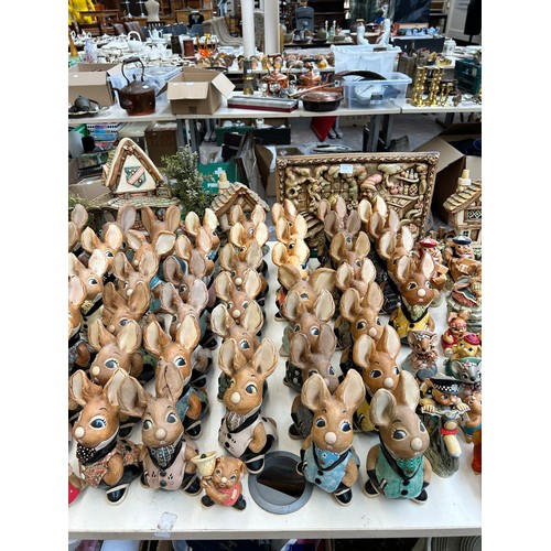 518 - An extensive collection of Pendelfin rabbit figurines and display stands to include Daisy Duck, Coll... 