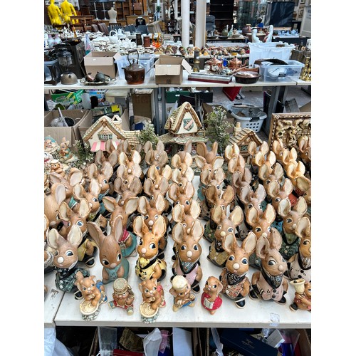 518 - An extensive collection of Pendelfin rabbit figurines and display stands to include Daisy Duck, Coll... 