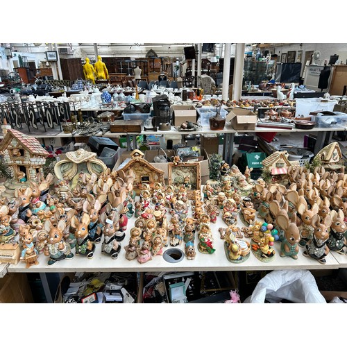 518 - An extensive collection of Pendelfin rabbit figurines and display stands to include Daisy Duck, Coll... 