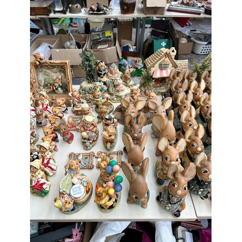 518 - An extensive collection of Pendelfin rabbit figurines and display stands to include Daisy Duck, Coll... 