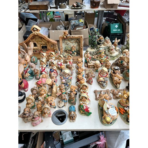 518 - An extensive collection of Pendelfin rabbit figurines and display stands to include Daisy Duck, Coll... 