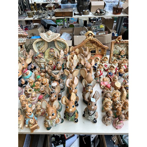 518 - An extensive collection of Pendelfin rabbit figurines and display stands to include Daisy Duck, Coll... 