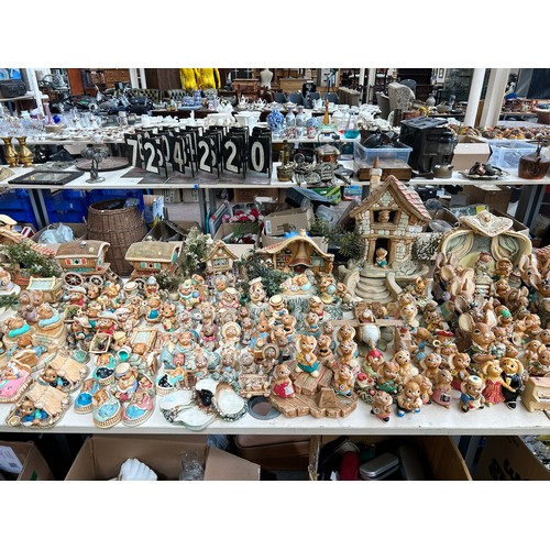 518 - An extensive collection of Pendelfin rabbit figurines and display stands to include Daisy Duck, Coll... 