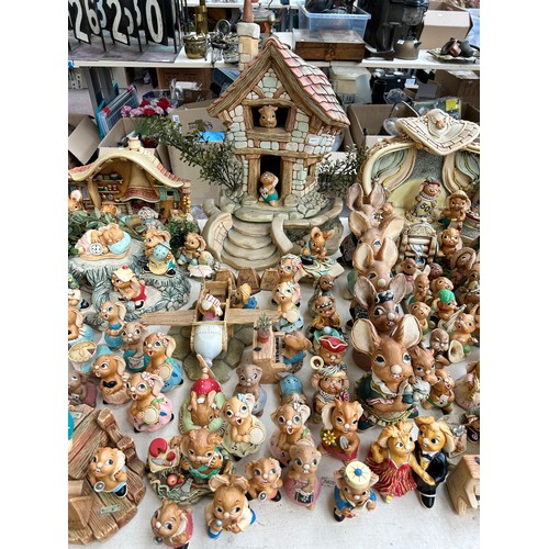 518 - An extensive collection of Pendelfin rabbit figurines and display stands to include Daisy Duck, Coll... 