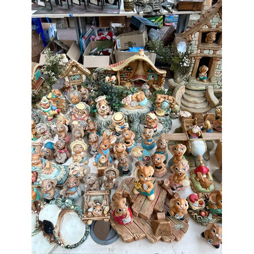 518 - An extensive collection of Pendelfin rabbit figurines and display stands to include Daisy Duck, Coll... 