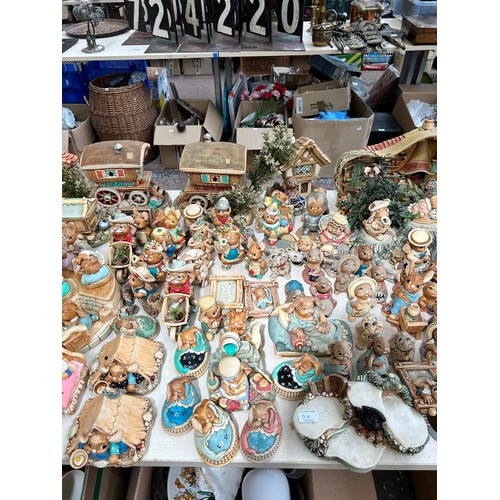 518 - An extensive collection of Pendelfin rabbit figurines and display stands to include Daisy Duck, Coll... 