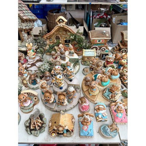 518 - An extensive collection of Pendelfin rabbit figurines and display stands to include Daisy Duck, Coll... 