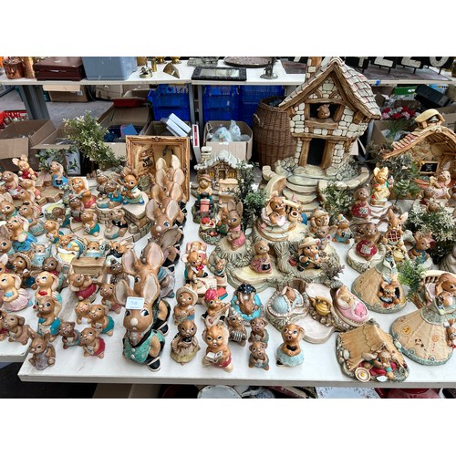 518 - An extensive collection of Pendelfin rabbit figurines and display stands to include Daisy Duck, Coll... 